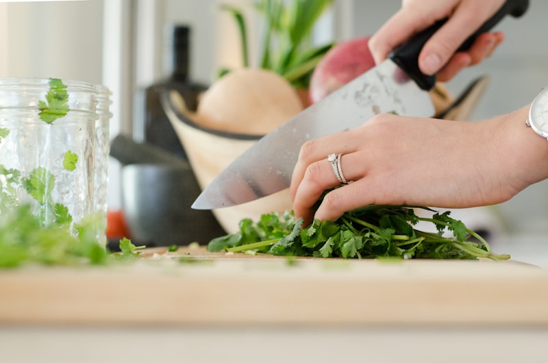 Home cook stirring a pot while following instructions on a phone